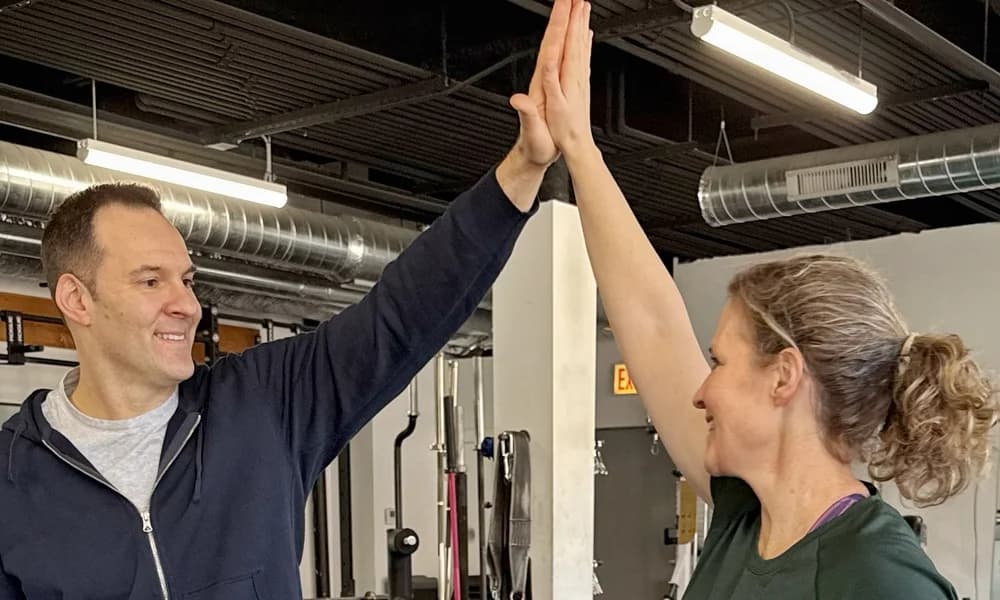 Dan and a client celebrating a training session with a high five